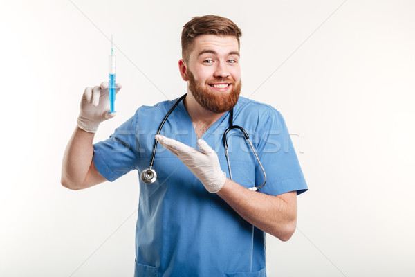 Portrait of a happy attractive medical doctor or nurse Stock photo © deandrobot