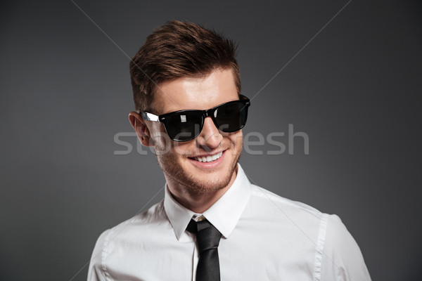 Cheerful young man dressed in formalwear Stock photo © deandrobot