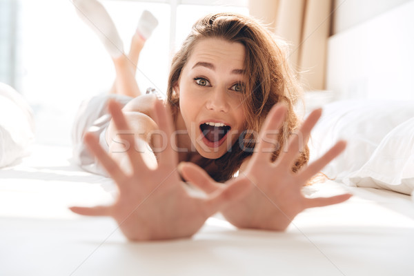 Fiatal nő készít stop kézmozdulat ágy fiatal Stock fotó © deandrobot