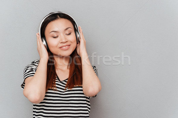 微笑 年輕 漂亮的女人 聽 音樂 頭戴耳機 商業照片 © deandrobot