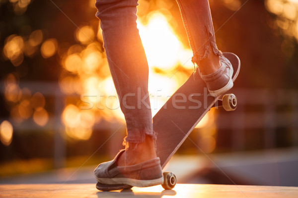 Stock photo: Close up of young male skateboarder training in skate park