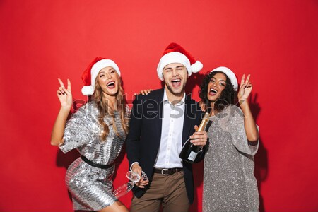 Excited happy young loving couple holding happy new year garland. Stock photo © deandrobot