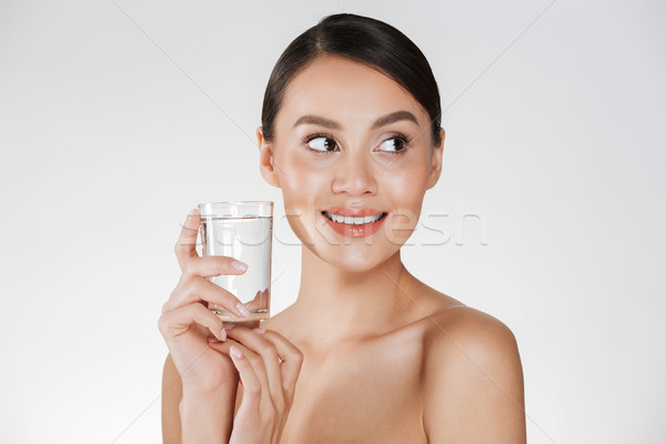 Beauty portrait of young happy woman with hair in bun drinking s Stock photo © deandrobot