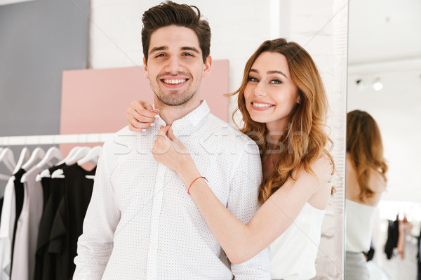 Smiling young couple standing at the clothing store Stock photo © deandrobot