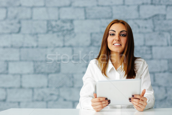 Laughing young businesswoman looking at camera Stock photo © deandrobot