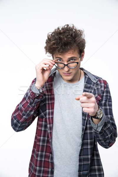 Young casual man in glasses pointing finger at camera Stock photo © deandrobot