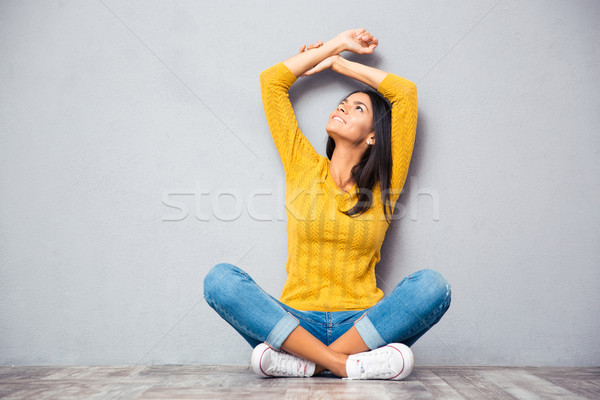 Woman sitting on the floor and looking up  Stock photo © deandrobot