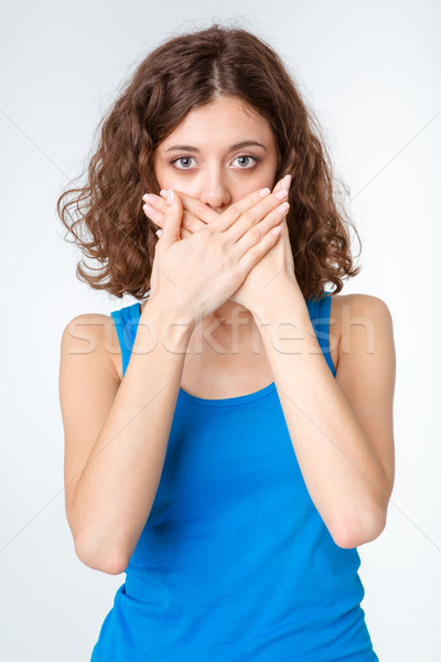 Woman covering her mouth Stock photo © deandrobot