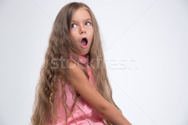 Portrait of shocked little girl looking away Stock photo © deandrobot