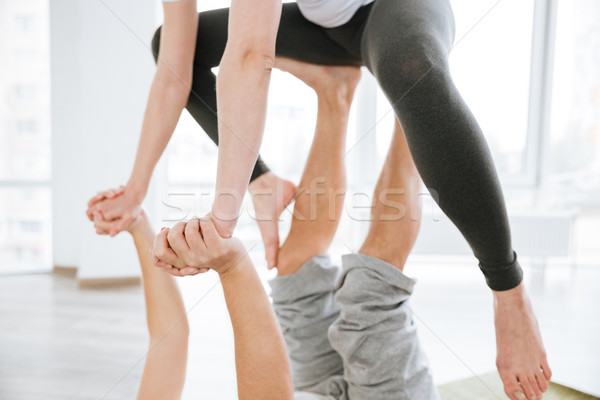 Man and woman doing acro yoga for couples in studio Stock photo © deandrobot