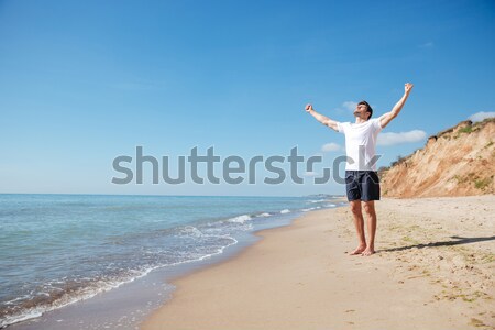 Feliz animado homem as mãos levantadas sucesso Foto stock © deandrobot