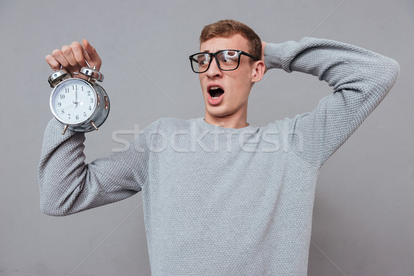 Somnolent homme verres horloge isolé gris [[stock_photo]] © deandrobot