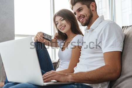 Happy interracial couple with laptop Stock photo © deandrobot