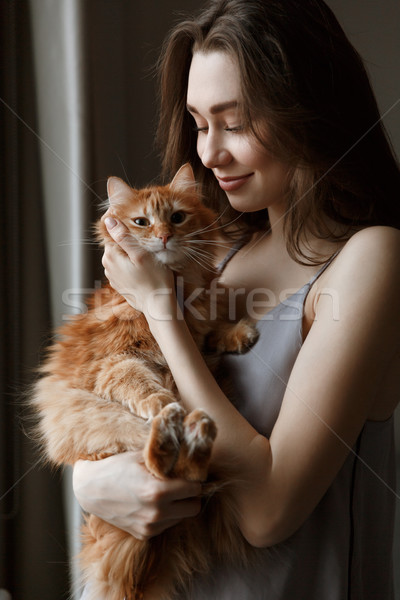 Vertical image of woman in nightie with cat Stock photo © deandrobot