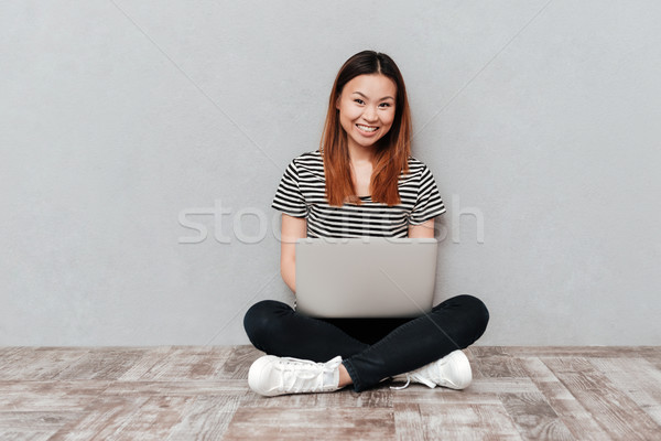 Positive heiter Frau Sitzung Stock Laptop Stock foto © deandrobot