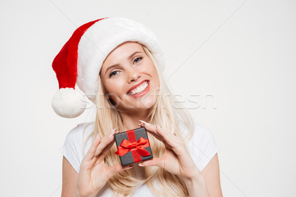 Stock photo: Close up portrait of a woman in red christmas hat