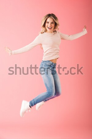 Young happy funny woman in casual clothes jumping isolated Stock photo © deandrobot