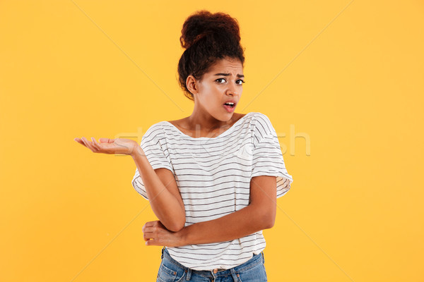 Young displeased lady looking camera isolated Stock photo © deandrobot