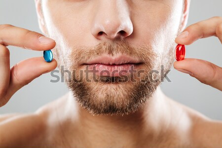 Closeup picture of good-looking adult guy grooming his face with Stock photo © deandrobot