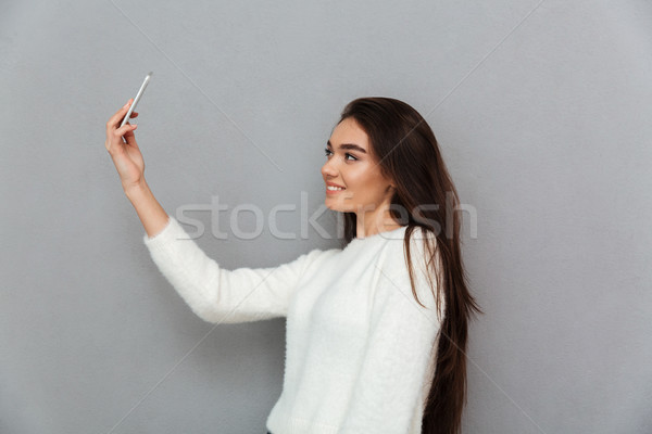 Close-up photo of charming brunette woman with long hair holding Stock photo © deandrobot