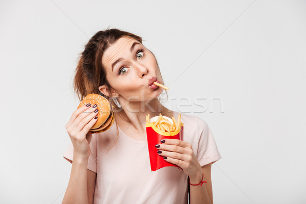 Close up portrait of a lovely pretty girl eating Stock photo © deandrobot