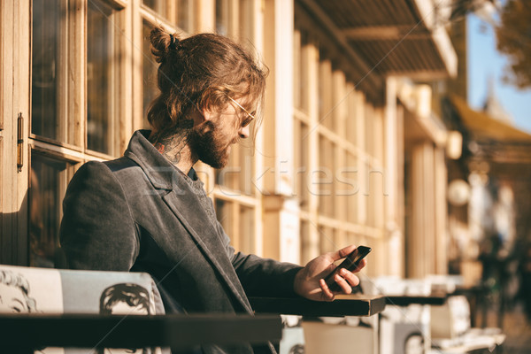 Portrait of a young bearded man dressed in coat Stock photo © deandrobot