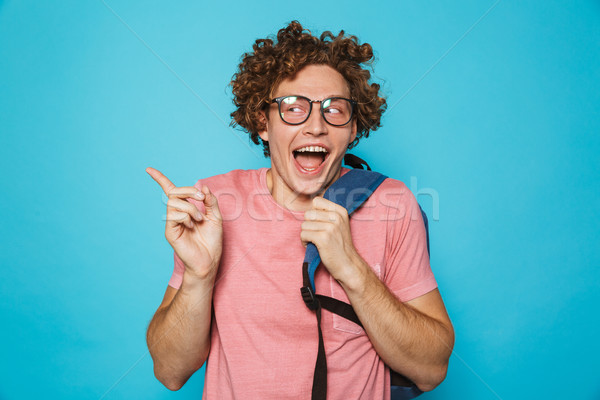 Stock photo: Photo of hipster geek man with curly hair wearing glasses and ba