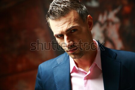 Trendy man standing over industrial background Stock photo © deandrobot