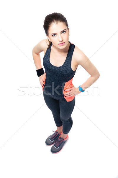 Serious sporty woman standing over white background Stock photo © deandrobot