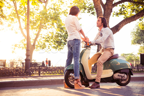 Fiatal romantikus pár flörtöl moped kint Stock fotó © deandrobot