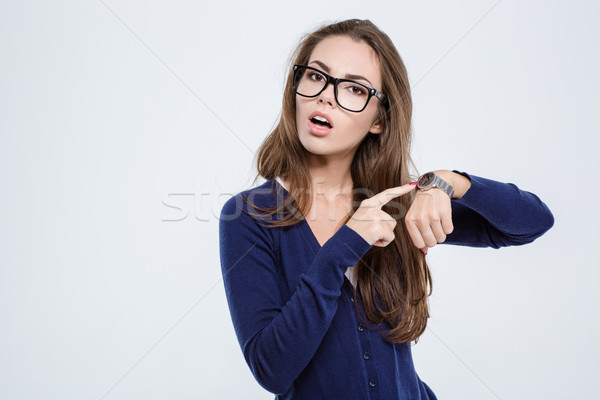 Woman pointing finger on wrist watch Stock photo © deandrobot
