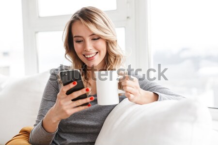 Kobieta bed smartphone portret uśmiechnięty Zdjęcia stock © deandrobot