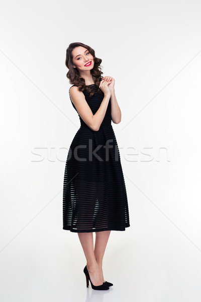 Full length of cheerful retro styled female in black dress  Stock photo © deandrobot