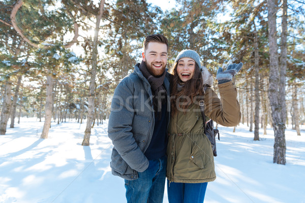Laughing couple standing in winter park Stock photo © deandrobot