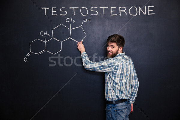 Happy man standing and drawing testosterone molecule chemical structure  Stock photo © deandrobot