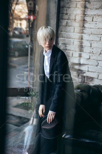 Cute blonde girl looking confused in modern cafe Stock photo © deandrobot