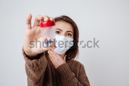 Woman in sweater and medical mask with tablets Stock photo © deandrobot