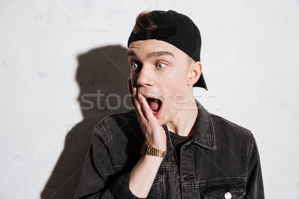 Surprised hipster in snap back Stock photo © deandrobot