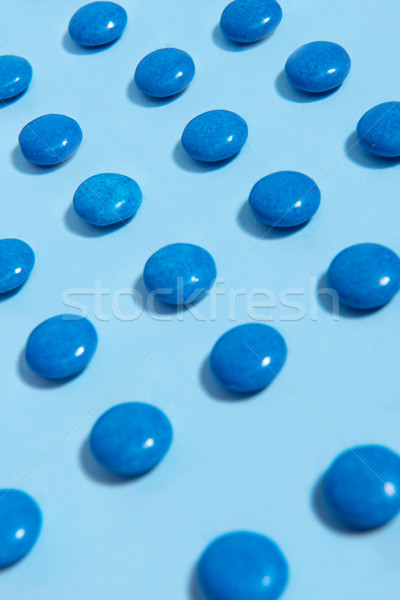 Colorful sweeties candy over blue table background. Stock photo © deandrobot
