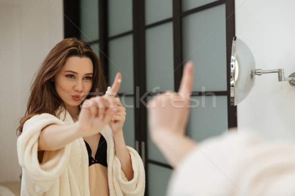 Kadın krem parmak bakıyor ayna banyo Stok fotoğraf © deandrobot