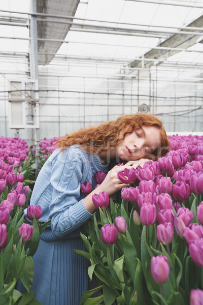 Girl lying on tulips Stock photo © deandrobot