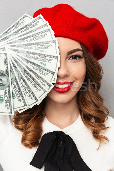 Close up portrait of a happy schoolgirl dressed in uniform showing bunch of money banknotes Stock photo © deandrobot