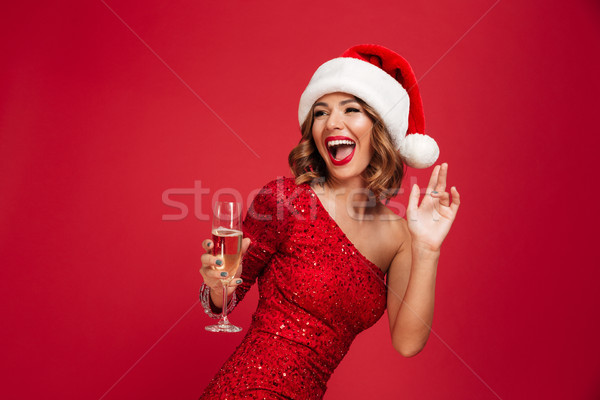 Portrait of a cheerful laughing woman in christmas hat Stock photo © deandrobot
