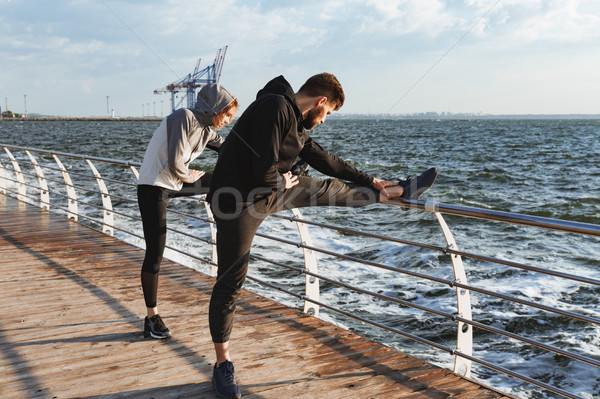 Sporty young couple warming up Stock photo © deandrobot