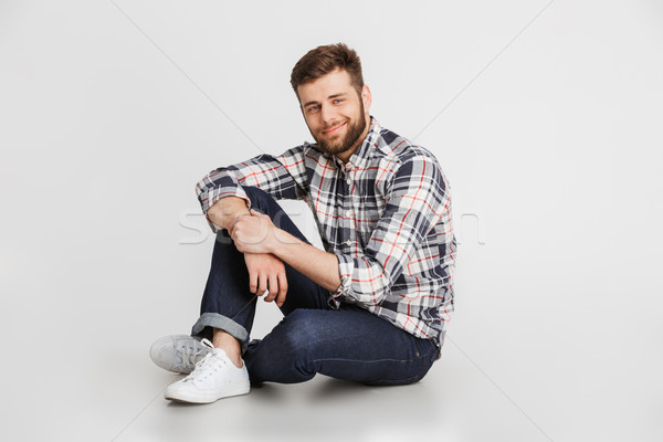 Portrait of a handsome young man in plaid shirt Stock photo © deandrobot