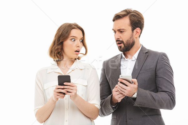 Portrait of a confused business couple Stock photo © deandrobot