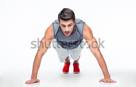 Sports man doing push ups Stock photo © deandrobot