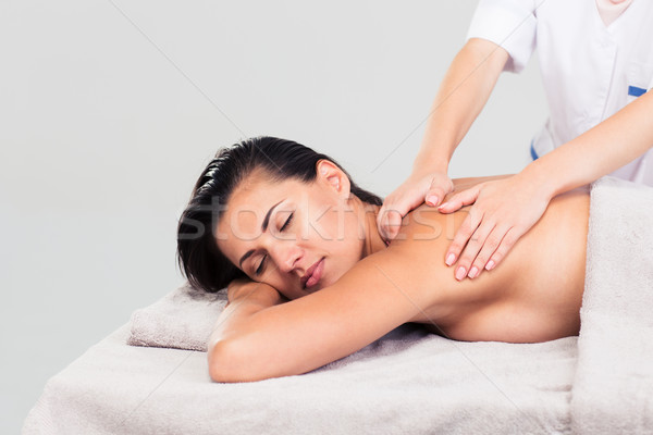 Woman lying on massage lounger Stock photo © deandrobot