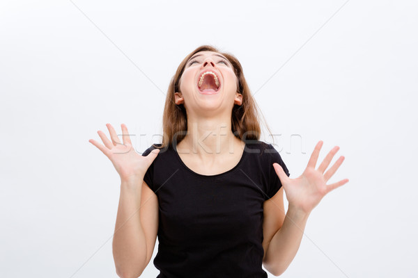 Crazy hysterical young woman screaming and  looking up Stock photo © deandrobot