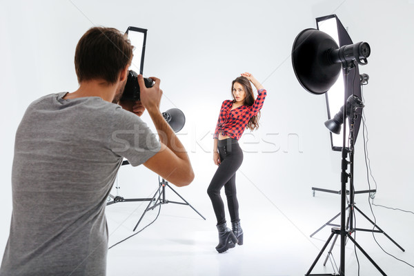 Photographer working with model in studio Stock photo © deandrobot
